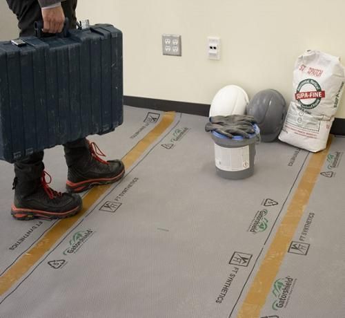 Floors lined with protective covering during a Rapid Rooter job