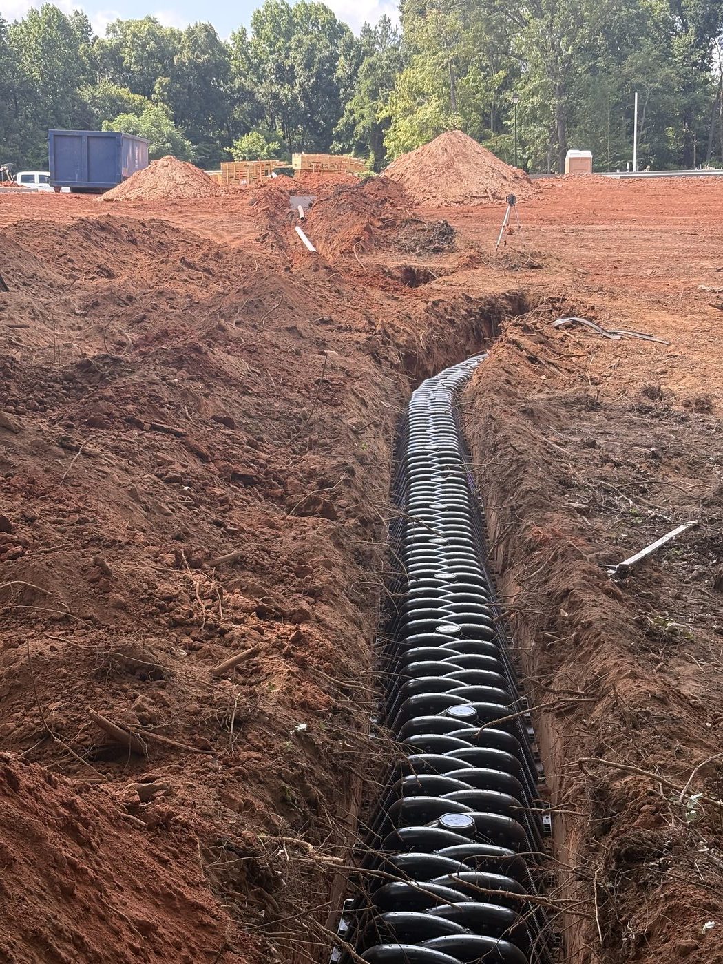 New septic line set in a trench in Carolina red clay by Rapid Rooter